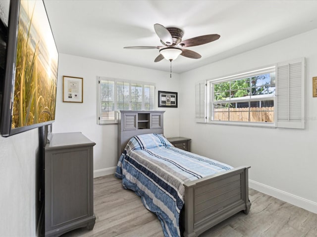 1666 N Dakota Ave NE, Saint Petersburg, FL 33703 - bedroom featuring multiple windows, light wood-type flooring, and baseboards