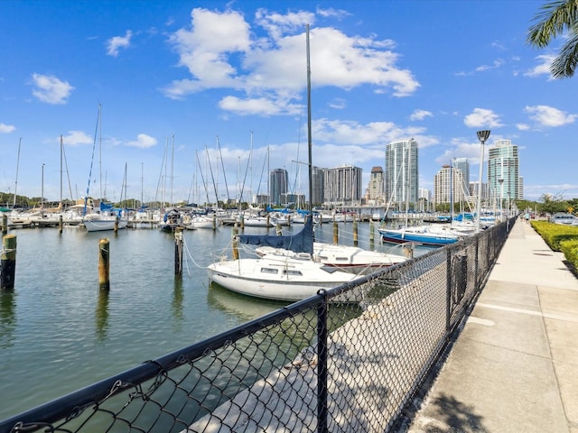 1666 N Dakota Ave NE, Saint Petersburg, FL 33703 - dock area featuring a view of city, a water view, and fence