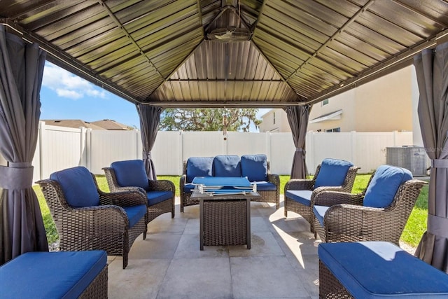 view of patio with a fenced backyard, a gazebo, and an outdoor hangout area