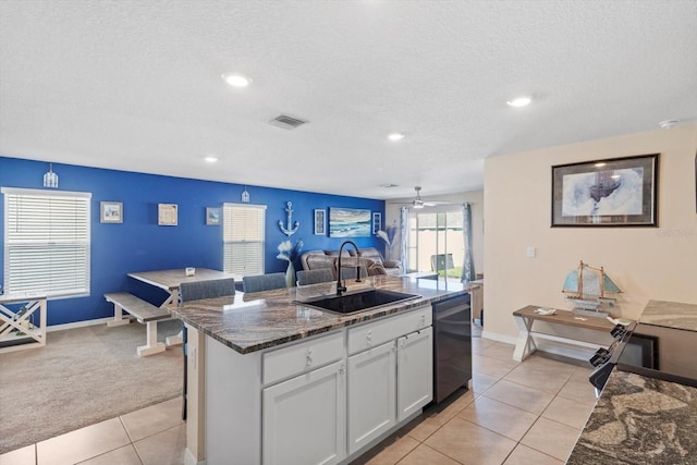 kitchen featuring a sink, white cabinetry, dishwasher, open floor plan, and visible vents