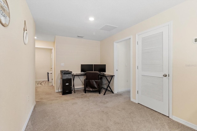 carpeted office space featuring baseboards, visible vents, and recessed lighting