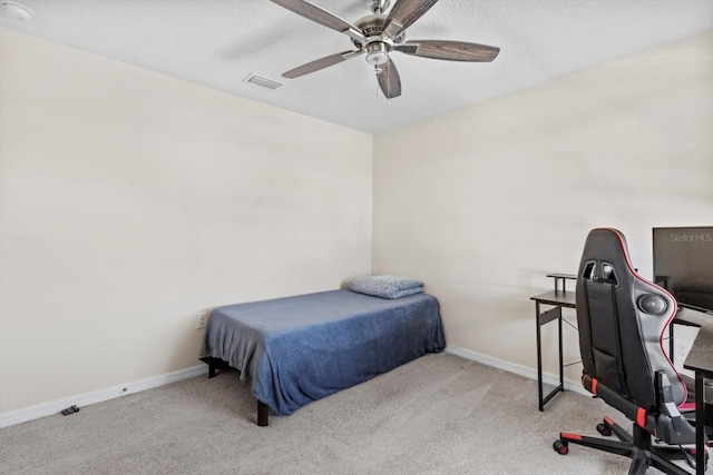 bedroom with baseboards, a ceiling fan, visible vents, and carpet