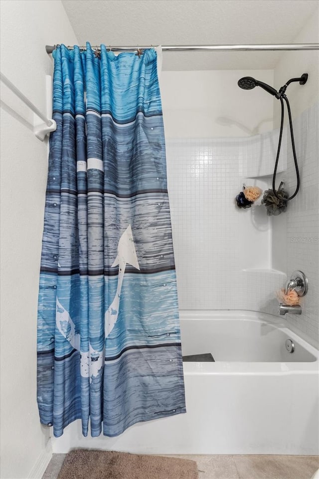 bathroom with shower / bath combo with shower curtain