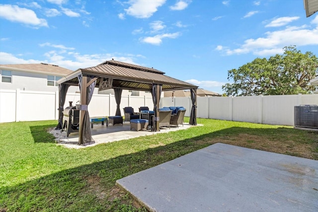 view of yard with a fenced backyard, a gazebo, cooling unit, and a patio area