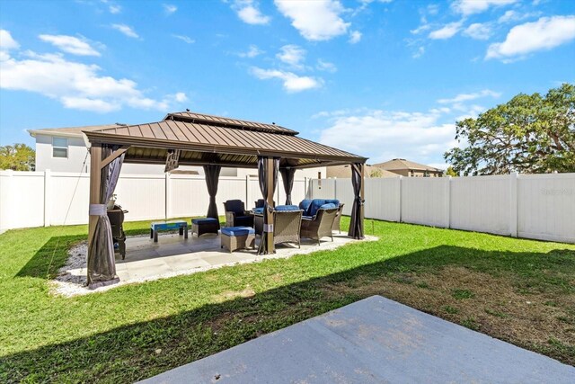 view of yard featuring a fenced backyard, a gazebo, and a patio area