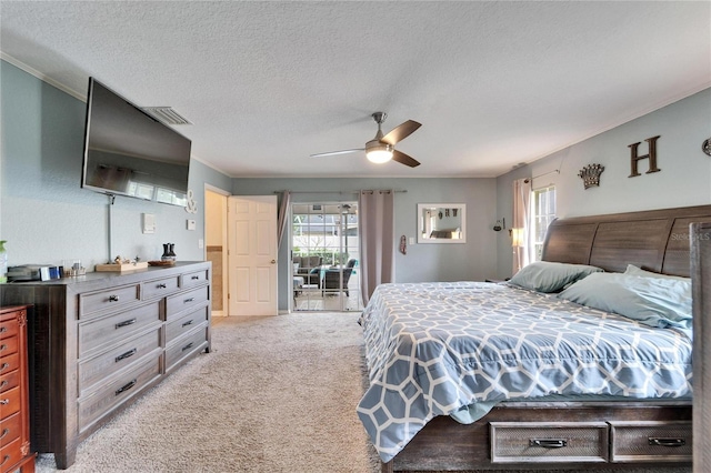 bedroom with light carpet, a textured ceiling, ornamental molding, and a ceiling fan