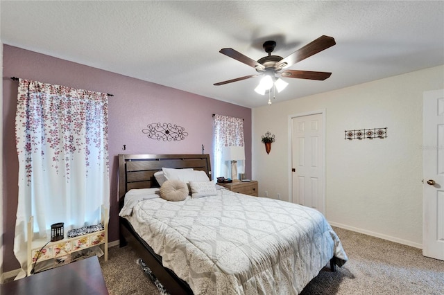 carpeted bedroom with baseboards, a textured ceiling, and a ceiling fan