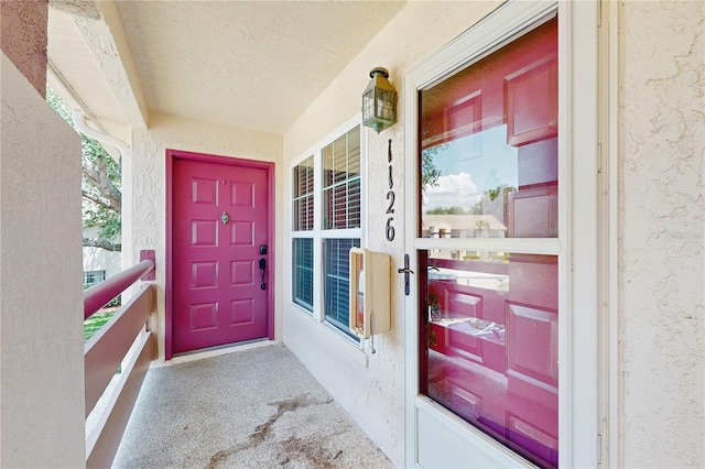 view of exterior entry featuring stucco siding