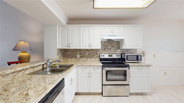 kitchen featuring stainless steel appliances, a sink, under cabinet range hood, and light tile patterned floors
