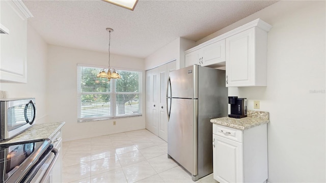 kitchen featuring appliances with stainless steel finishes, white cabinetry, a chandelier, a textured ceiling, and hanging light fixtures