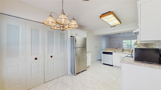 kitchen with freestanding refrigerator, dishwasher, a chandelier, a sink, and white cabinets