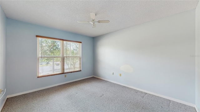 empty room with carpet, a textured ceiling, baseboards, and a ceiling fan
