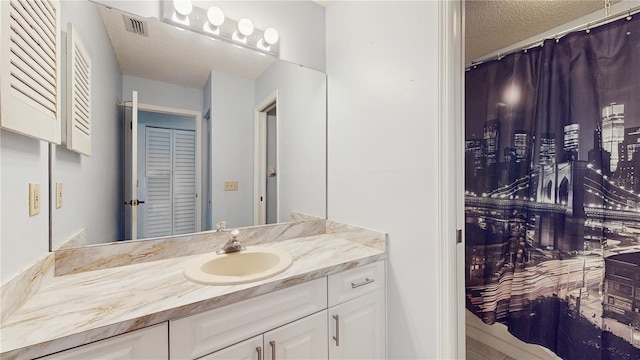 bathroom with vanity and a textured ceiling