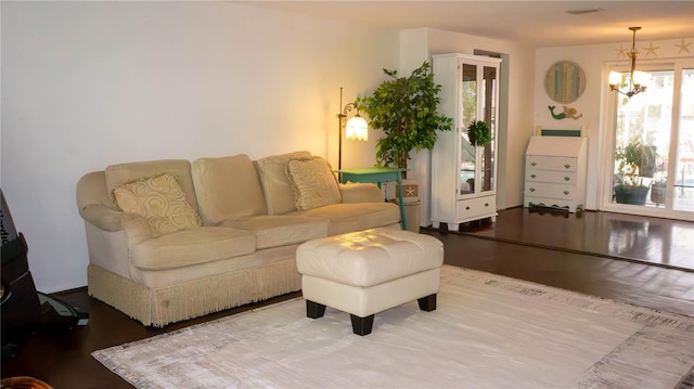 living room featuring a notable chandelier and wood finished floors