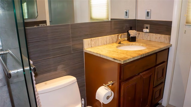 bathroom with an enclosed shower, toilet, and vanity