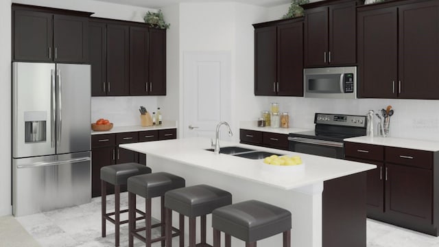 1919 Blissful Dr, Kissimmee, FL 34744 - kitchen featuring an island with sink, light countertops, a sink, a kitchen bar, and appliances with stainless steel finishes