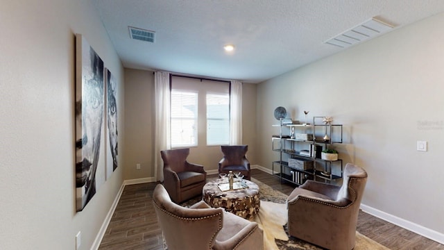 1919 Blissful Dr, Kissimmee, FL 34744 - living area with baseboards, visible vents, and wood finished floors
