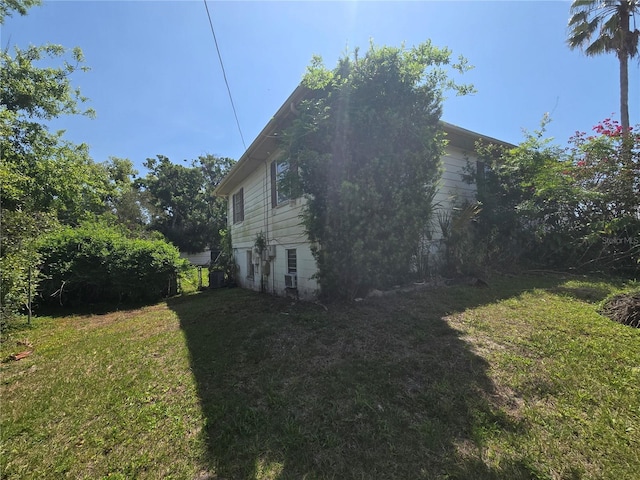 view of property exterior with a yard