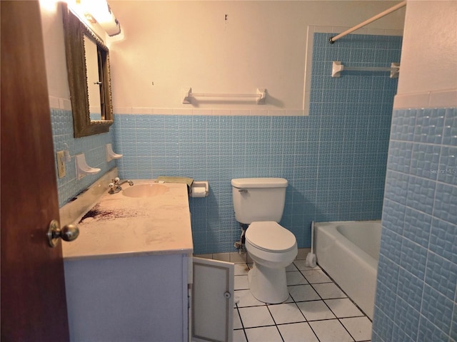 full bathroom with toilet, tile walls, bathtub / shower combination, vanity, and tile patterned floors