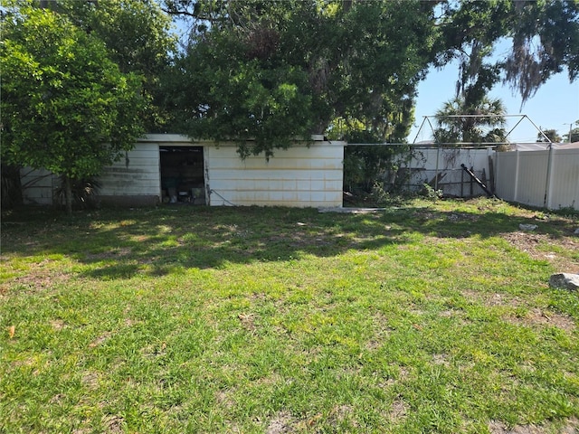 view of yard with an outbuilding and fence