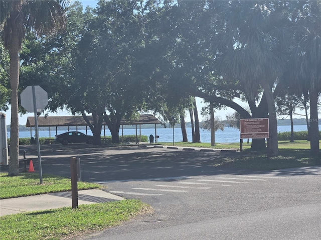 view of street featuring a water view and traffic signs