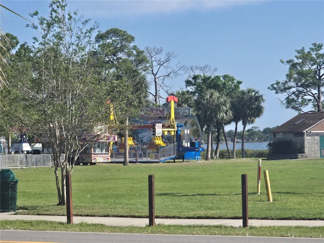 view of home's community featuring fence and a lawn