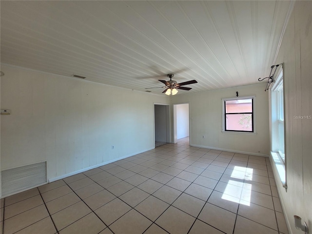 empty room with light tile patterned floors, ceiling fan, and visible vents
