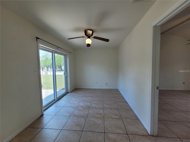 unfurnished room with light tile patterned floors, baseboards, a ceiling fan, and visible vents
