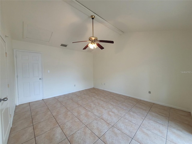 empty room featuring a ceiling fan, vaulted ceiling, visible vents, attic access, and baseboards