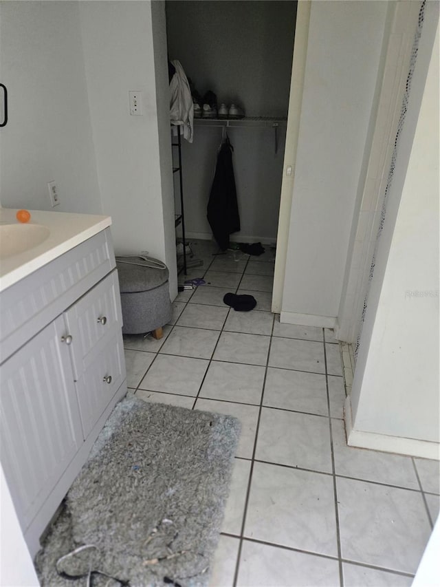 bathroom with tile patterned flooring and vanity