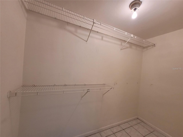 walk in closet featuring light tile patterned flooring