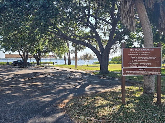 view of home's community with uncovered parking and a water view