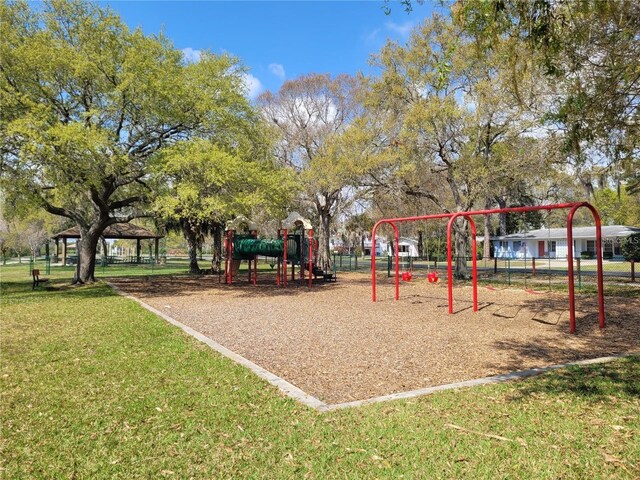 view of community with a lawn and playground community