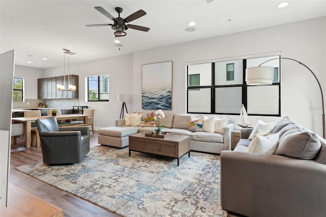 907 Arlington Ave N, Saint Petersburg, FL 33705 - living area featuring visible vents, wood finished floors, recessed lighting, and ceiling fan with notable chandelier