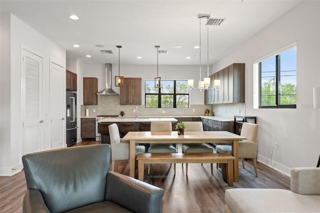 907 Arlington Ave N, Saint Petersburg, FL 33705 - dining room with wood finished floors, baseboards, and visible vents