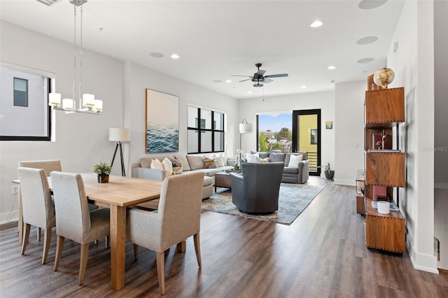 907 Arlington Ave N, Saint Petersburg, FL 33705 - dining room with dark wood finished floors, ceiling fan with notable chandelier, baseboards, and recessed lighting