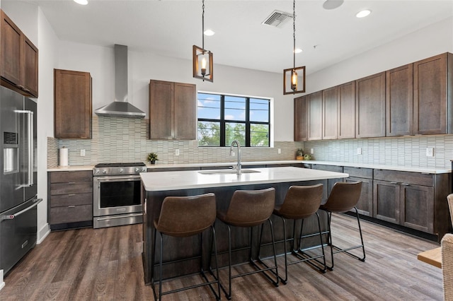 907 Arlington Ave N, Saint Petersburg, FL 33705 - kitchen with high end refrigerator, stainless steel electric range oven, a sink, visible vents, and wall chimney range hood