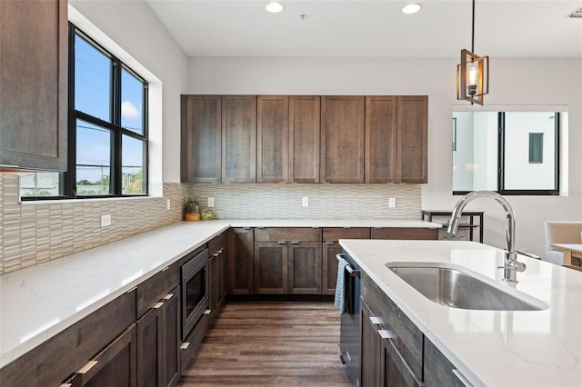 907 Arlington Ave N, Saint Petersburg, FL 33705 - kitchen with recessed lighting, stainless steel appliances, decorative backsplash, a sink, and light stone countertops