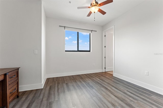907 Arlington Ave N, Saint Petersburg, FL 33705 - empty room featuring baseboards, wood finished floors, and a ceiling fan