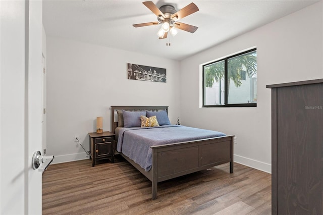 907 Arlington Ave N, Saint Petersburg, FL 33705 - bedroom featuring baseboards, wood finished floors, and a ceiling fan