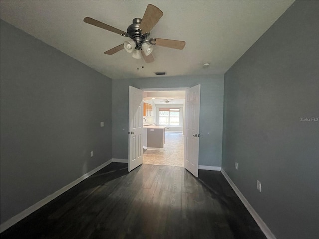 4731 Portobello Cir, Valrico, FL 33596 - empty room featuring dark wood-style floors, baseboards, and a ceiling fan