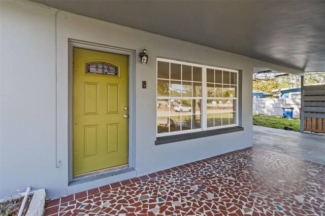 1411 Barry St, Clearwater, FL 33756 - view of exterior entry featuring stucco siding and fence
