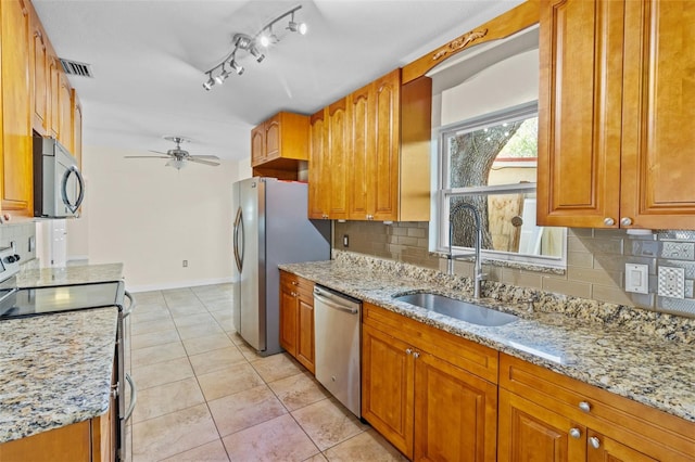 1411 Barry St, Clearwater, FL 33756 - kitchen featuring a sink, light stone countertops, appliances with stainless steel finishes, light tile patterned floors, and visible vents