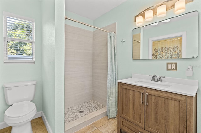 1411 Barry St, Clearwater, FL 33756 - bathroom with baseboards, a tile shower, toilet, vanity, and tile patterned flooring