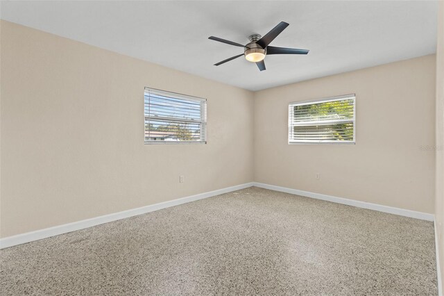 1411 Barry St, Clearwater, FL 33756 - unfurnished room with baseboards, speckled floor, and ceiling fan
