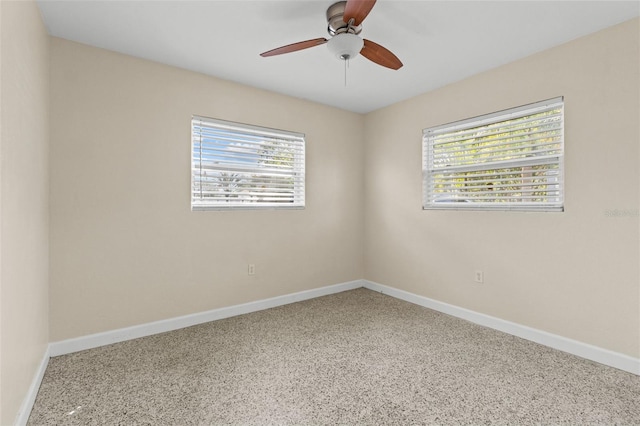 1411 Barry St, Clearwater, FL 33756 - spare room with baseboards, a ceiling fan, and a healthy amount of sunlight