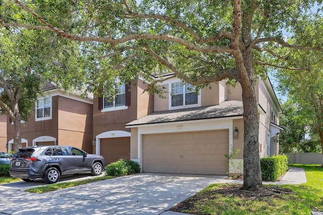 view of front of property featuring an attached garage, stucco siding, and driveway