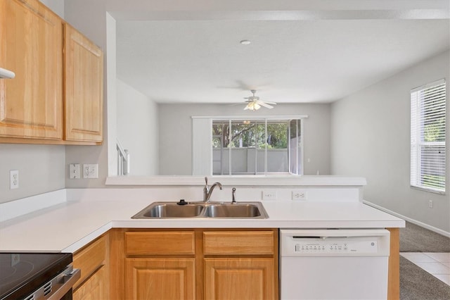kitchen featuring dishwasher, a sink, healthy amount of natural light, and light countertops