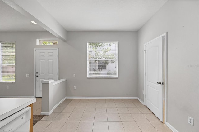 empty room with light tile patterned flooring and baseboards
