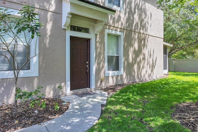 entrance to property featuring stucco siding